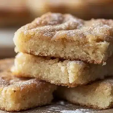 Freshly baked cinnamon sugar blondies topped with a sprinkle of cinnamon sugar.