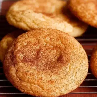 Baked easy snickerdoodles with cinnamon sugar topping on a plate