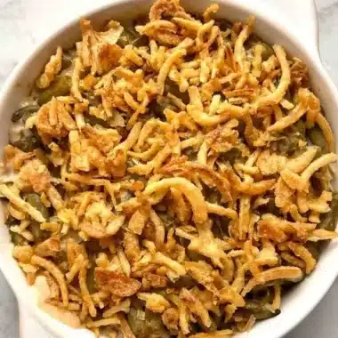 Delicious green bean casserole topped with crispy onions and creamy sauce