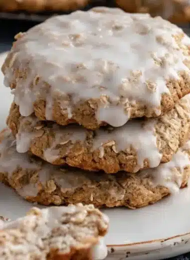 Delicious iced oatmeal cookies with a sweet glaze on a decorative plate.