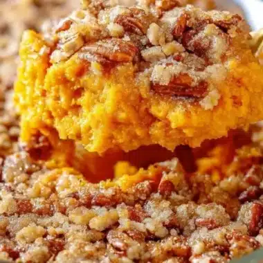 Delicious Southern sweet potato casserole garnished with pecans and marshmallows.