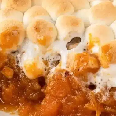 Sweet Potato Casserole with Marshmallows 1 Sweet potato casserole topped with marshmallows, served in a baking dish.
