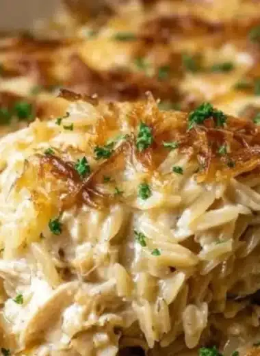 Delicious French Onion Chicken Orzo Casserole topped with cheese